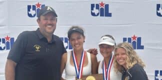 Two female tennis players in white dresses pose with medals on a wooden trophy, flanked by a man and a woman coach in front of a UIL backdrop.