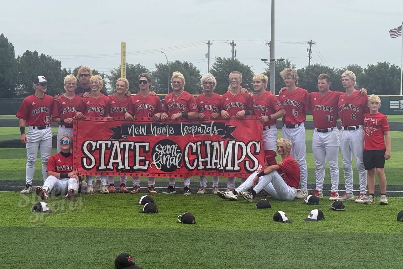 New Home Leopards baseball team posing on the field with a 'State Champs' banner.