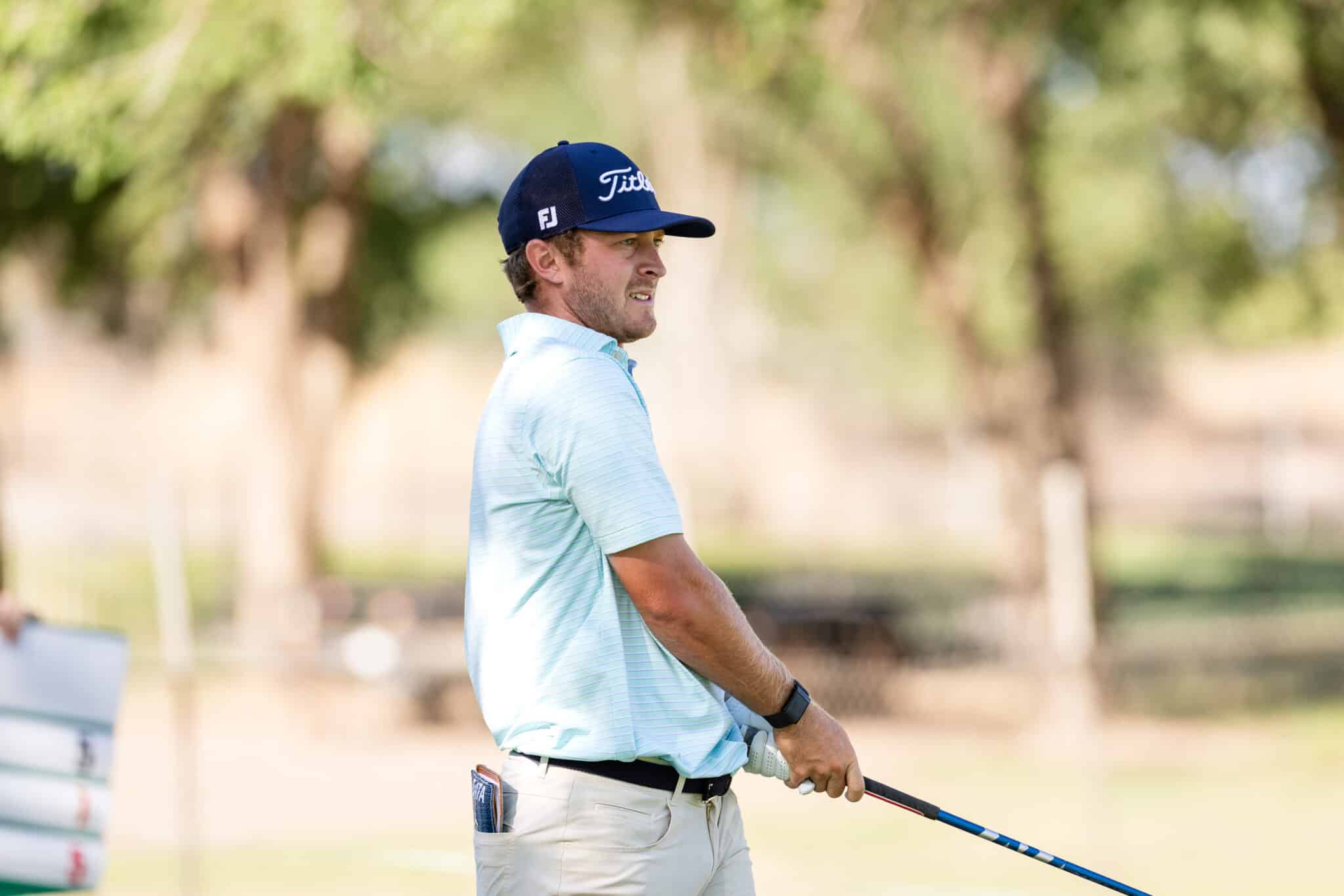 korn-ferry-occunet-classic-day-1-jpegJoe-361 | Press Pass Sports Man golfing on a sunny course, wearing a light blue polo and white pants with a Titleist cap, holding a golf club