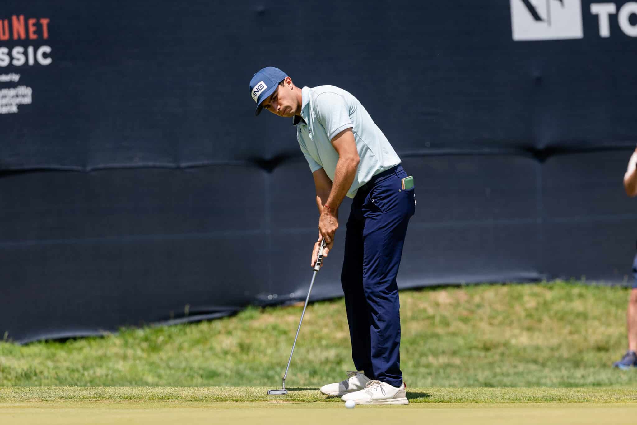 korn-ferry-occunet-classic-day-2-jpegJoe-244 | Press Pass Sports Golfer preparing to putt on the green, wearing a light polo, navy pants and a blue cap.