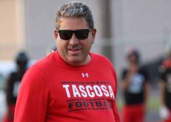 Tascosa - Ken Plunk 2 | Press Pass Sports Man wearing a red Tascosa Football shirt and dark sunglasses, outdoors during daytime.