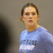 1K6A5628 | Press Pass Sports Woman with light brown hair tied back, wearing a blue athletic shirt with 'West Plains' text, looking off to her right in a gym or indoor setting.