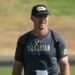 1K6A1920 | Press Pass Sports Coach outdoors wearing a navy CANADIAN shirt, black cap, and lanyard.