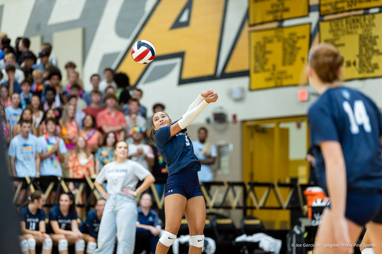 west-plains-vs-amarillo-high-2026-jpegJoe-pps-8 | Press Pass Sports Female volleyball player spikes the ball during a match as a crowd watches from the bleachers in a gymnasium