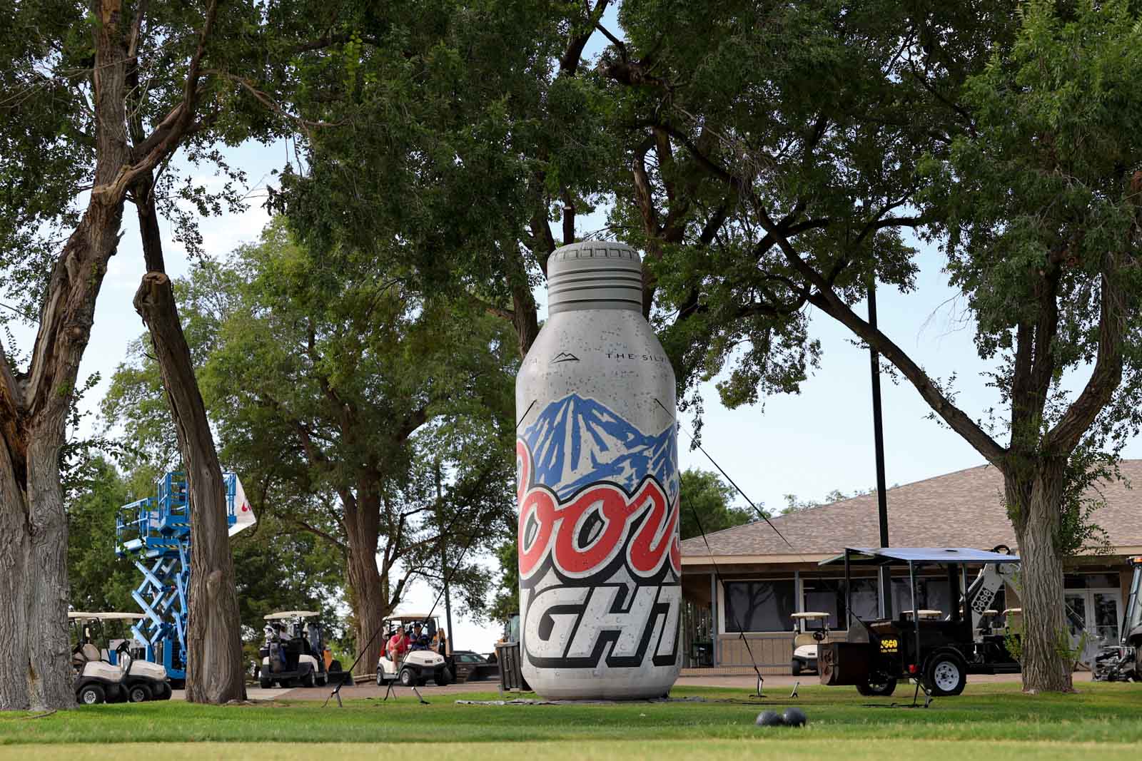 CoorTOC_FinalDay-1 | Press Pass Sports Giant inflatable soda can prop in a park, with trees and people at an outdoor event in the background.