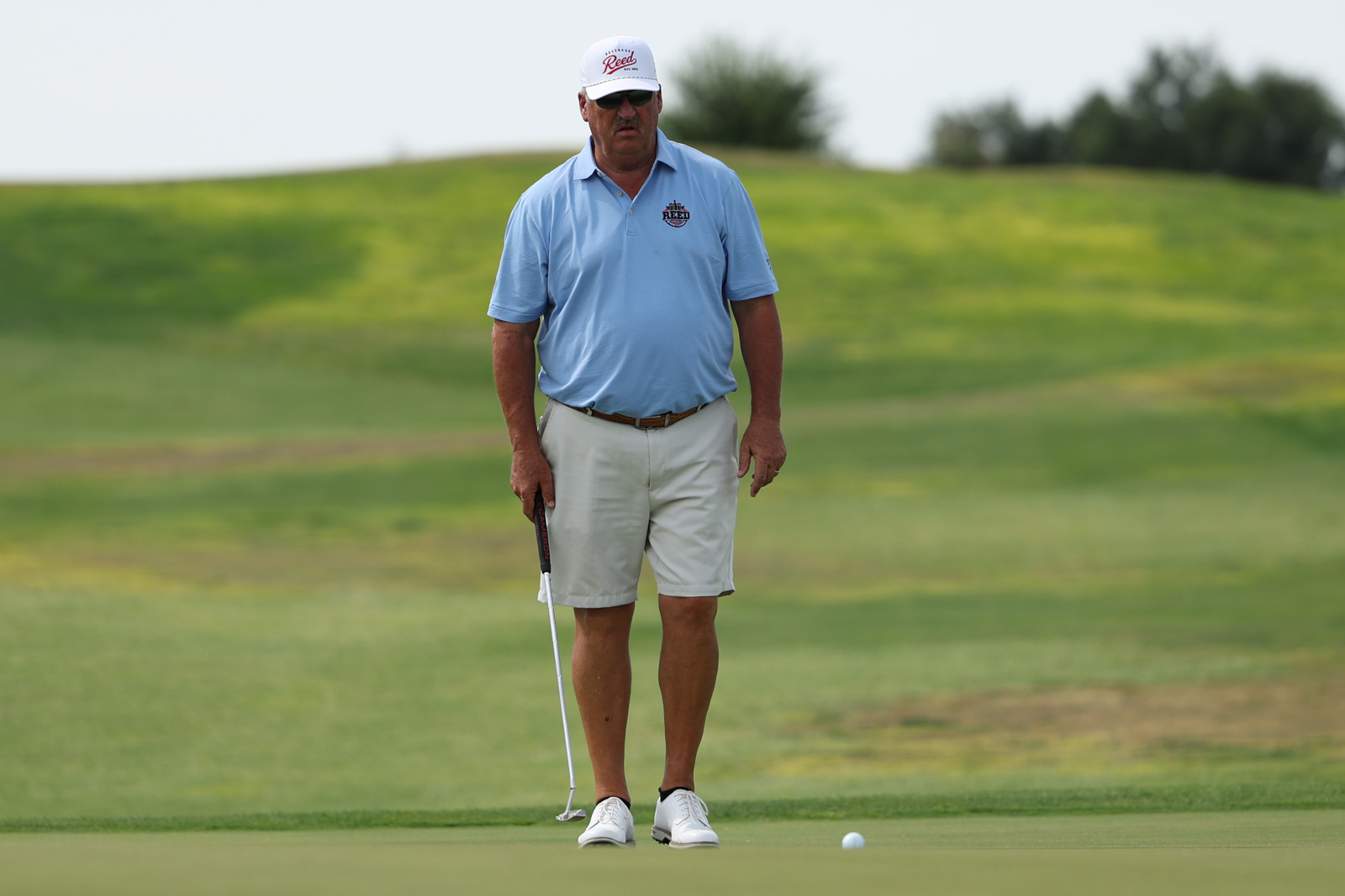 CoorTOC_FinalDay-39 | Press Pass Sports Golfer wearing a light blue polo and white cap lines up a putt on a green.