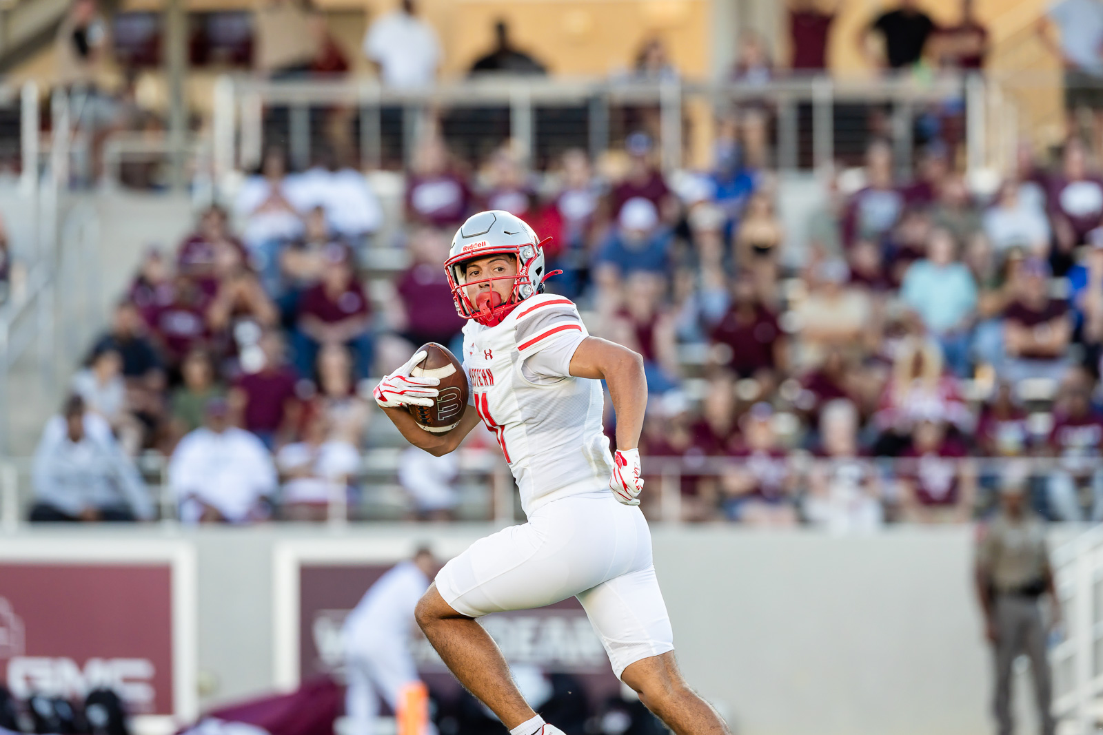 western-colorado-vs-wtamu-jpegJoe-pps-28 | Press Pass Sports American football player in white and red uniform running with ball on a stadium field, crowd in background