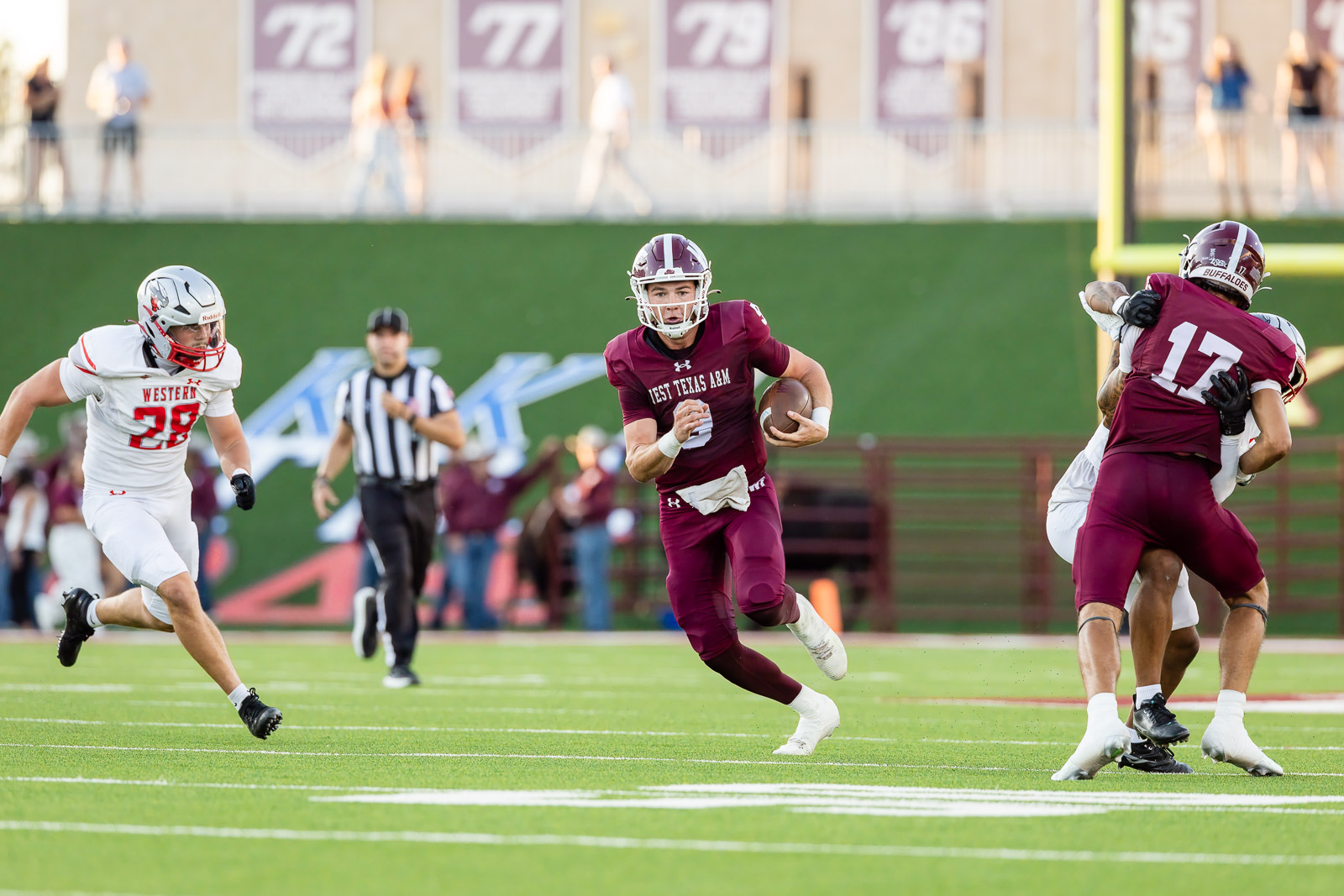 western-colorado-vs-wtamu-jpegJoe-pps-34 | Press Pass Sports West Texas A&M running back in maroon carries the ball, sprinting down the field as a white-uniform defender pursues.