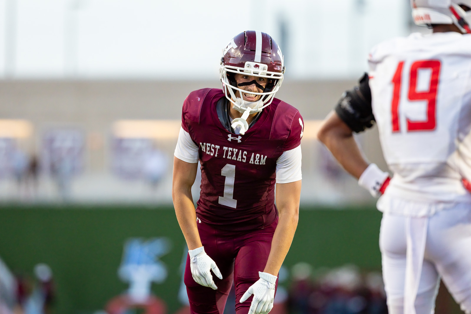 western-colorado-vs-wtamu-jpegJoe-pps-53 | Press Pass Sports West Texas A&M football player in maroon jersey #1 on the field during a game, facing an opponent in white jersey 19