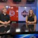 Two news anchors stand at a desk in a studio, a large screen behind them shows the red 'P' logo and a 'The Locker Room' graphic for Fox 14.