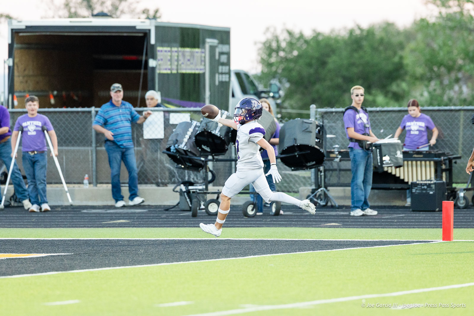 panhnandle-vs-canadian-football-jpegJoe-pps-15 | Press Pass Sports Football player in white uniform catches a pass near the end zone with a crowd watching in the background.