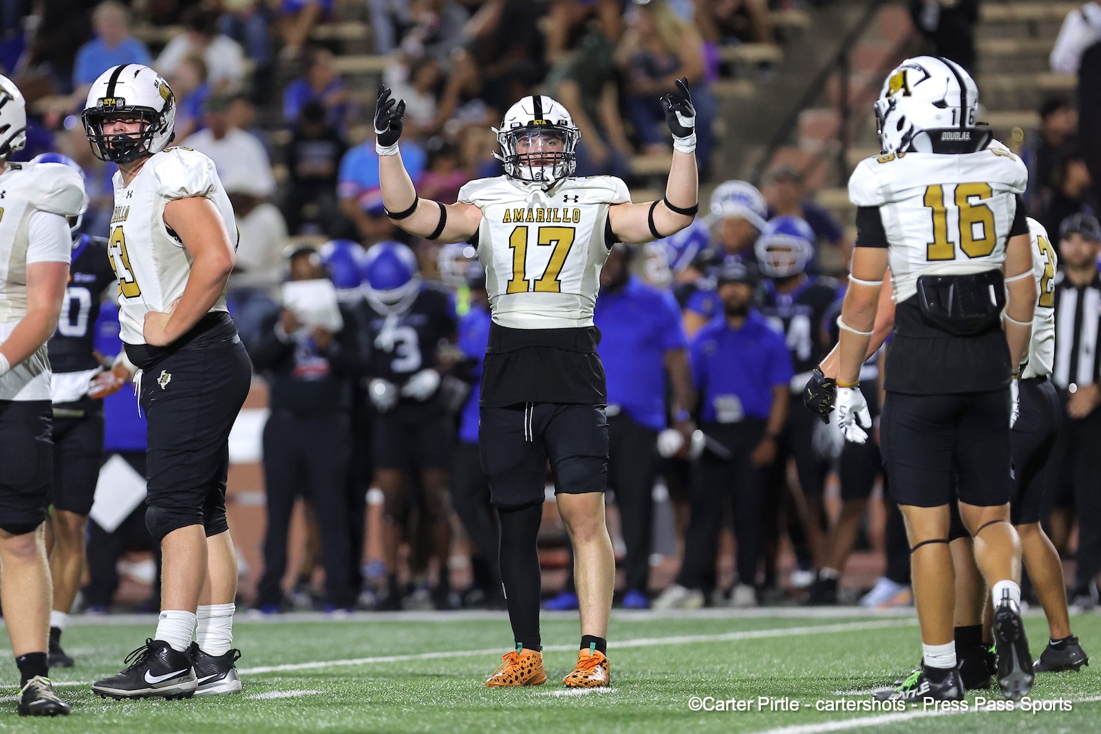 Football player wearing number 17 from Amarillo raises his arms in celebration on the field, with teammates and a crowd in the background.