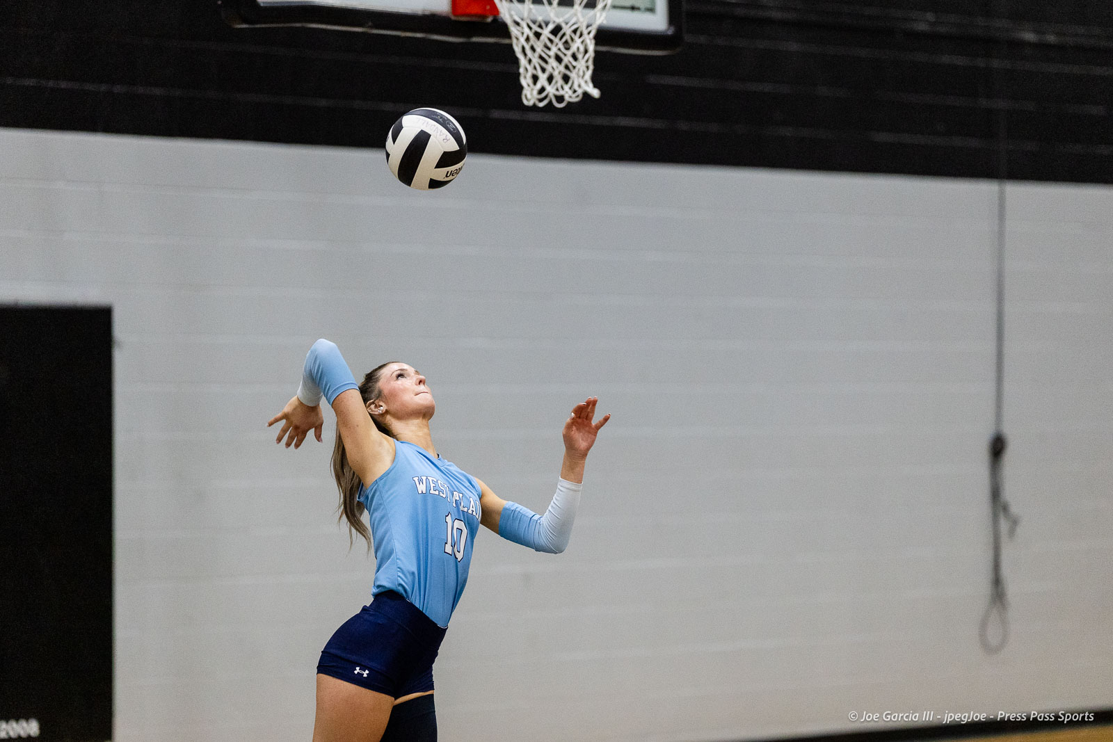 randall-showcase-2026-jpegJoe-pps-54 | Press Pass Sports Female volleyball player in a light blue Westlake jersey #10 serves the ball indoors.