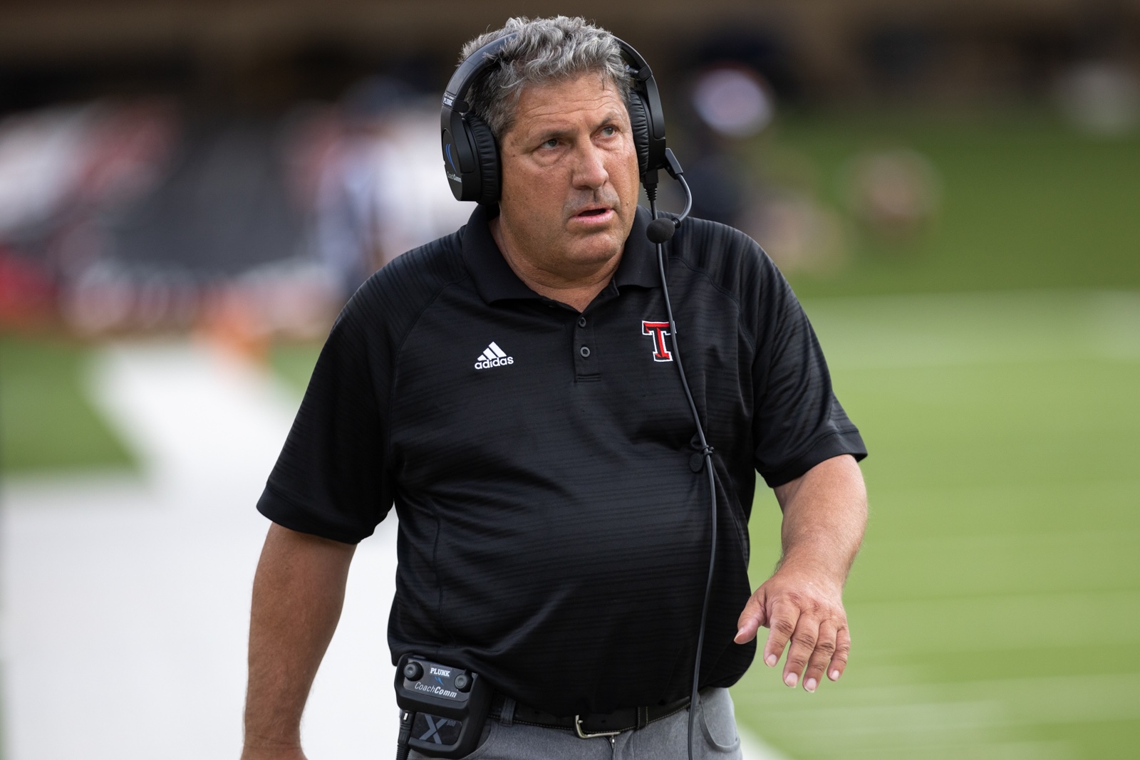 THS-CHS-FB-13 | Press Pass Sports Coaching staff member wearing a headset on a football sideline, focused and ready to coach on a sunny day