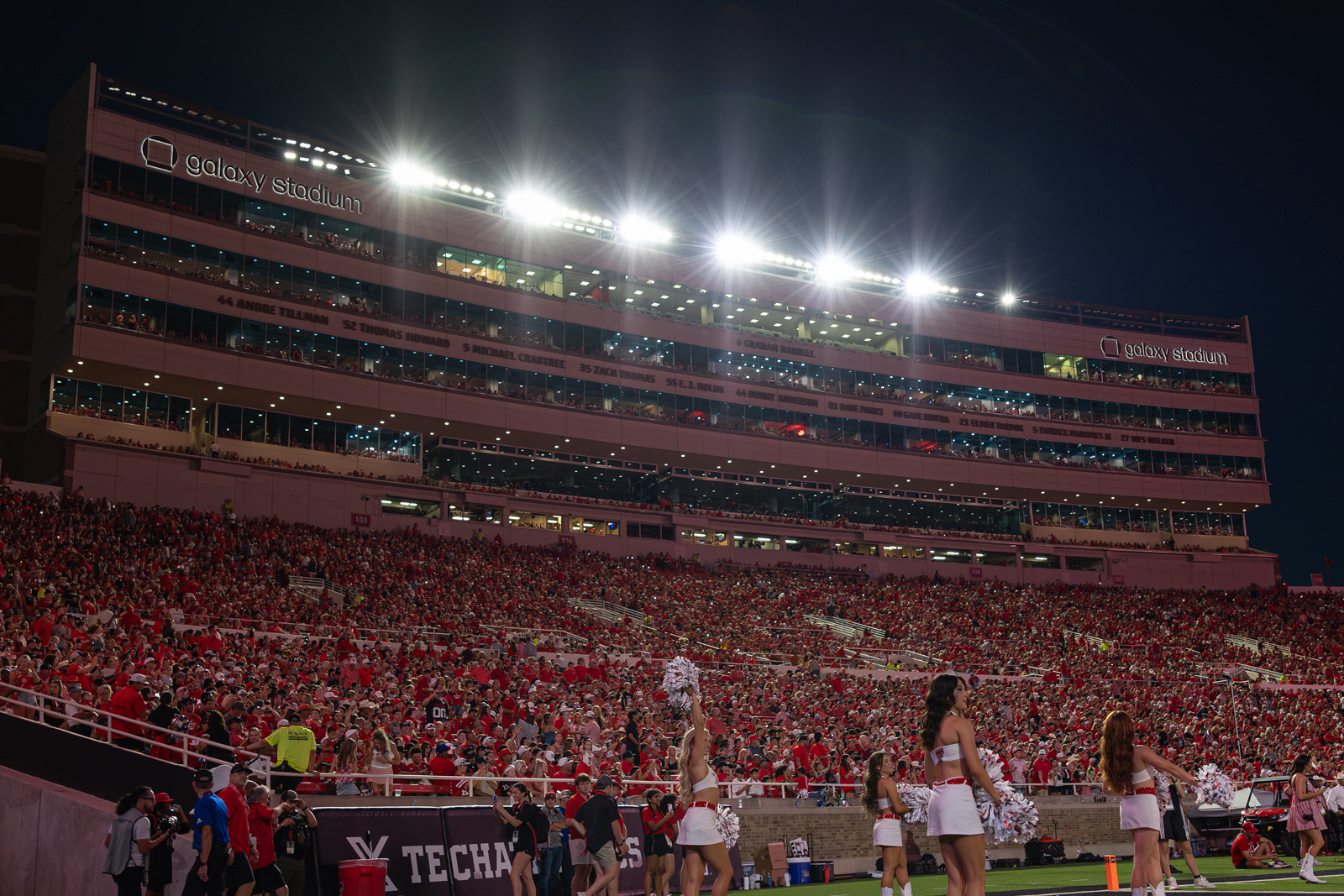 Tech-Abilene-FB-26 | Press Pass Sports Nighttime view of Galaxy Stadium filled with red-clad fans and bright floodlights overhead.