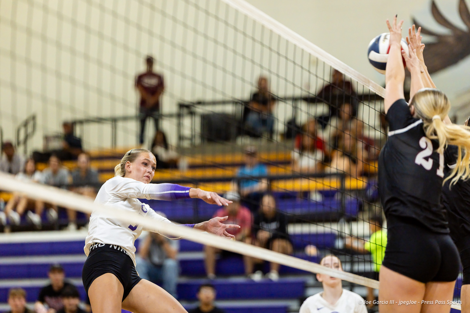 herford-vs-canyon-volleyball-jpegJoe-pps-2 | Press Pass Sports Blonde volleyball player in white jersey spikes the ball toward the net, as defenders jump to block.