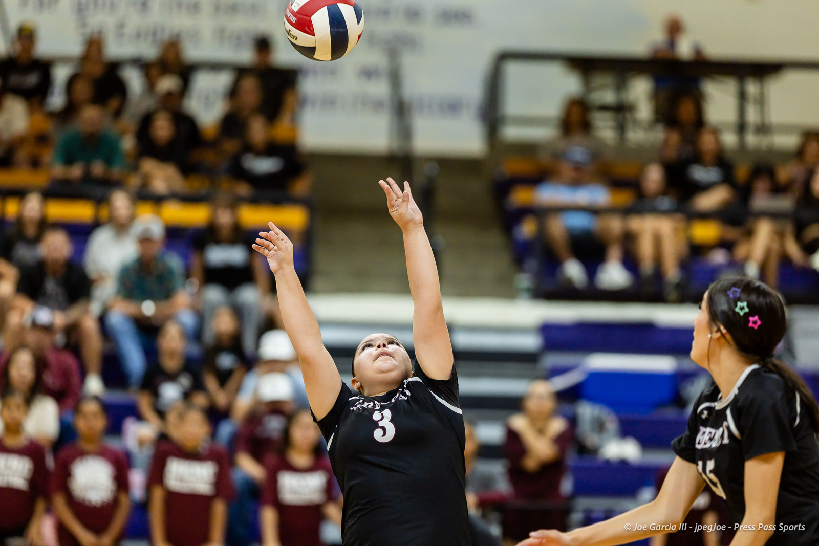 herford-vs-canyon-volleyball-jpegJoe-pps-18 | Press Pass Sports Female volleyball player wearing number 3 reaches up to contact a ball during a match; blurred crowd in gym background.