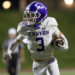 Cap-Can-42 | Press Pass Sports Canyon football player in white jersey (#3) sprinting with the ball tucked under his left arm, purple helmet visible.