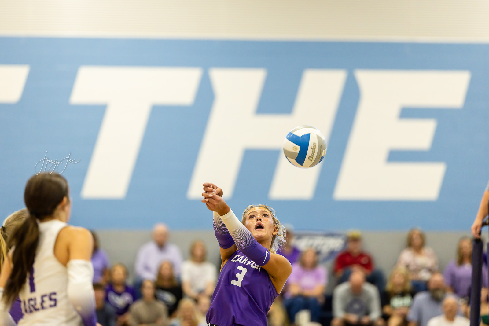 canyon-vs-west-plains-jpegJoe-volleyball-pps-43 | Press Pass Sports Female volleyball player in a purple uniform (#3) attempting a set as a ball comes toward her in a gym with spectators in the background.