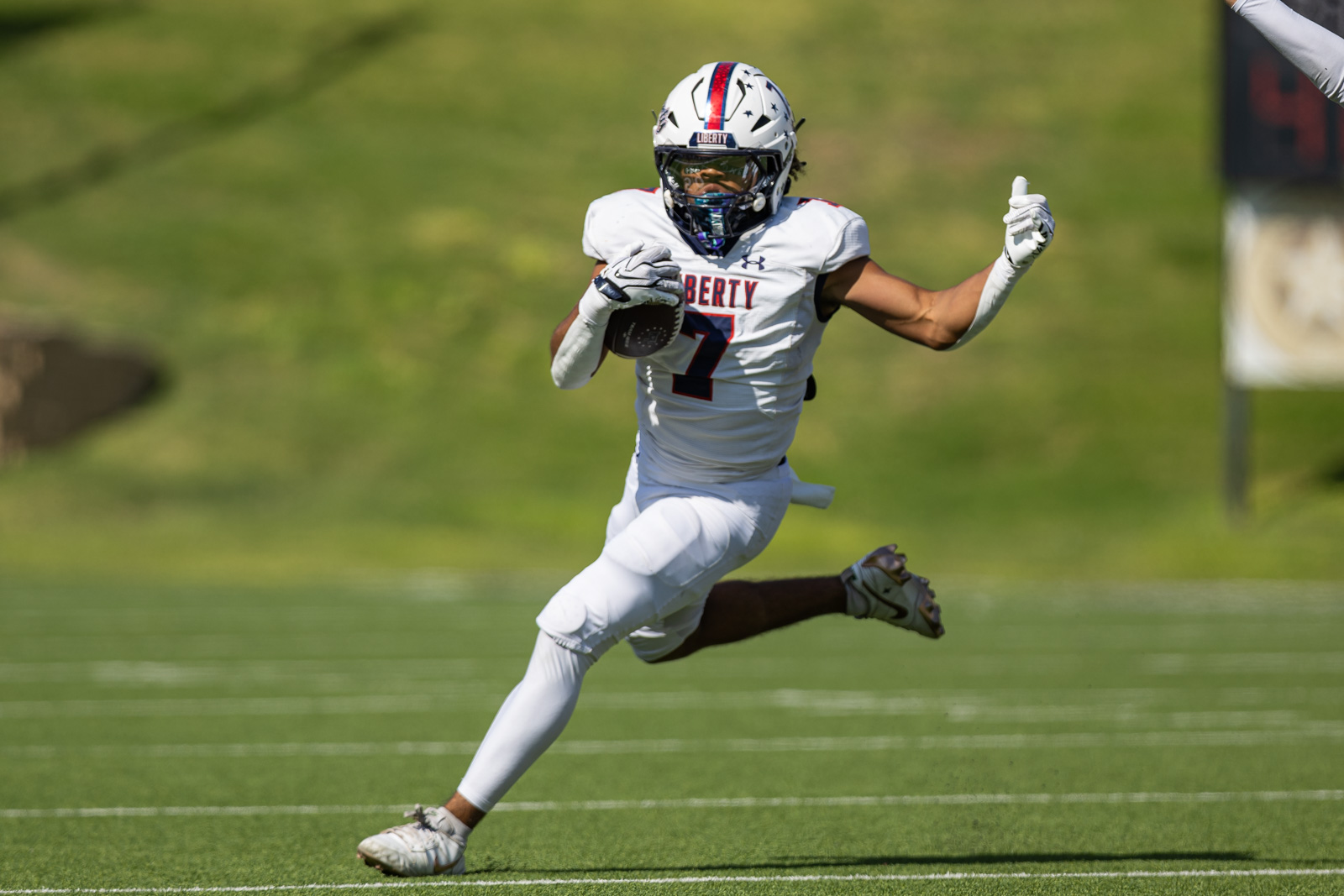 LHS-WPHS-FB-19 | Press Pass Sports Football player in a white Liberty jersey (number 7) sprinting with the ball on a green field.
