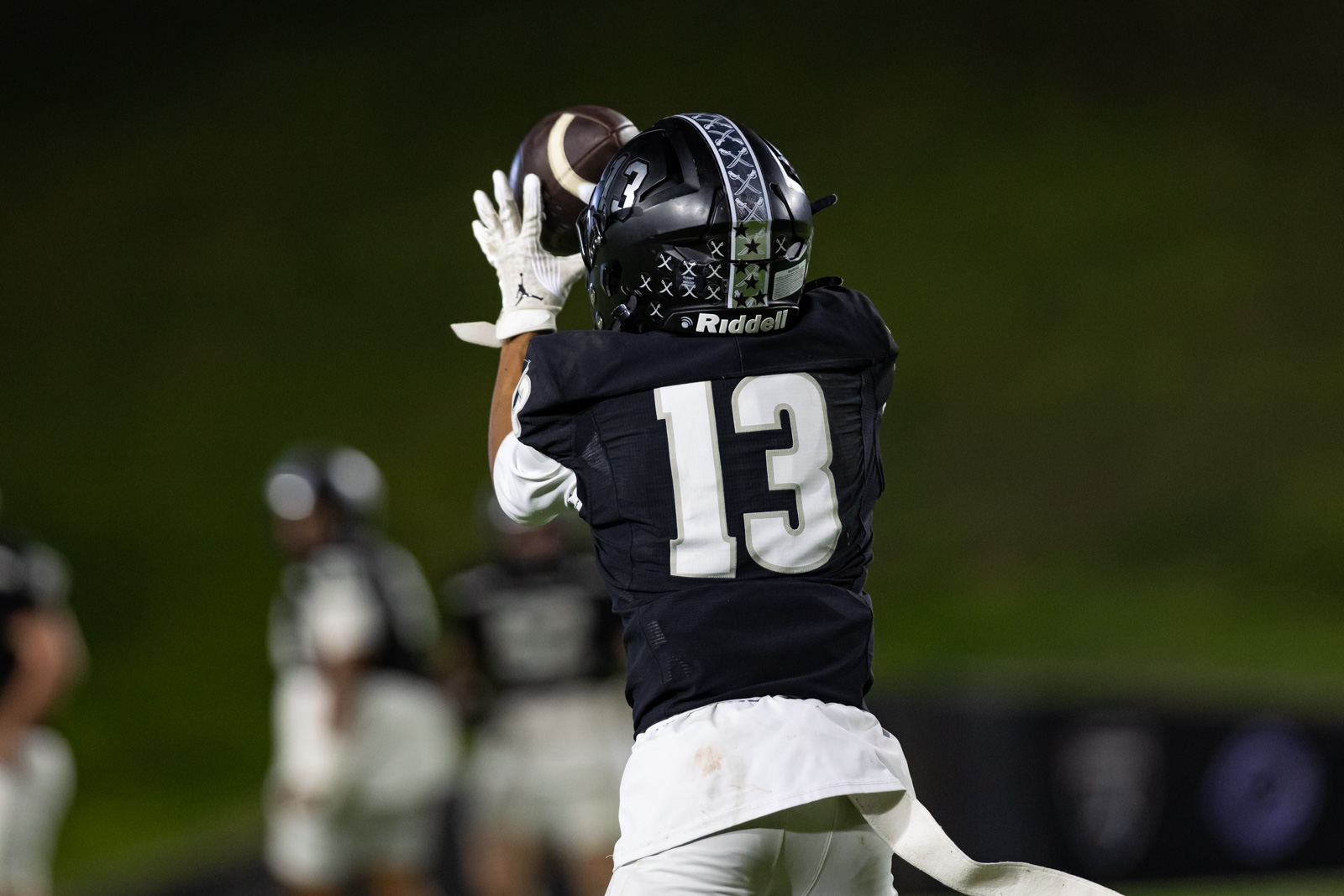 CHS-RHS-FB-42 | Press Pass Sports Football player in a black jersey with number 13 catching a pass at night, white gloves visible.