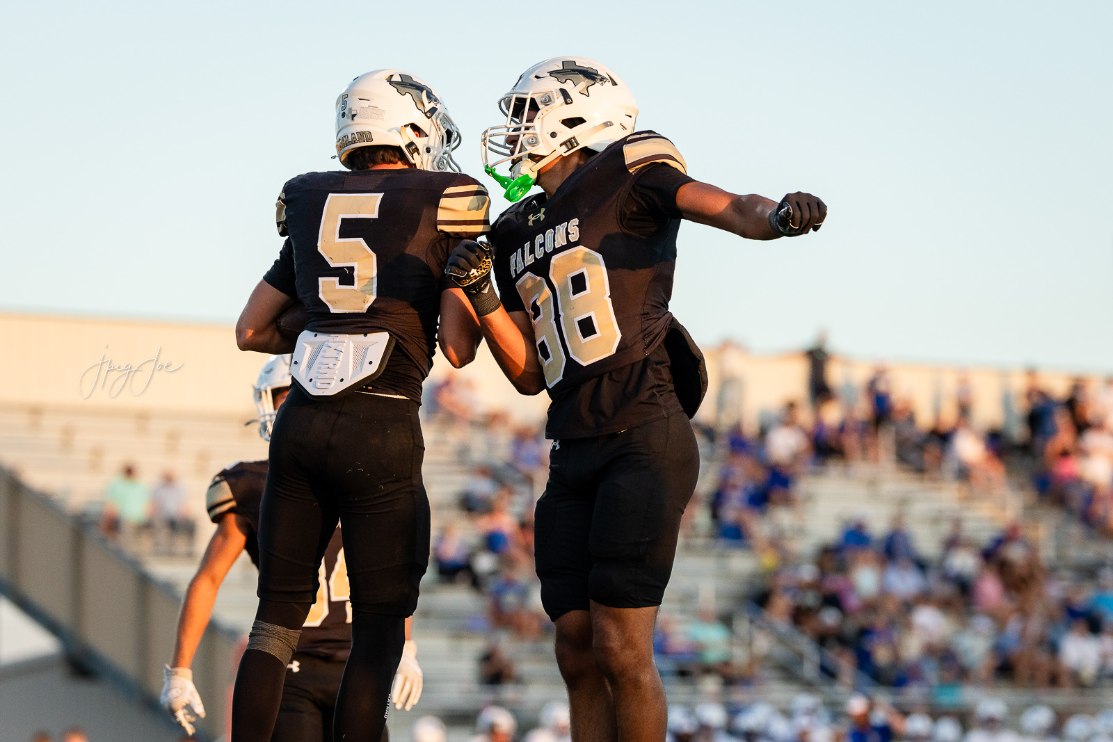 lubbock-christian-vs-bushland-football-jpegJoe-19 | Press Pass Sports Two football players in black Falcons uniforms celebrate on the field, arms around each other after a play.