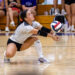 CHS-RHS-VB-5 | Press Pass Sports Volleyball player dives low to dig the ball on a polished gym floor, with spectators in the background.