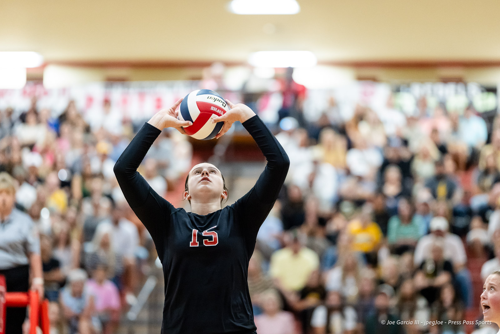 amarillo-high-vs-tascosa-volleyball-jpegJoe-pps-10 | Press Pass Sports Female volleyball player in a black jersey with number 15 prepares to set the ball during a crowded indoor match.