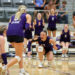 20260922-Kelton-Miami-VB-043 | Press Pass Sports Women’s volleyball game in a gym; players in purple uniforms cheer as one dives for the ball near the floor, with a white-uniform opponent on the right.