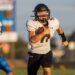 Liberty_15-10 | Press Pass Sports Football player in a white jersey with the number 17, black helmet, running with the ball during a game.