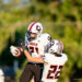 gruver-vs-wellinton-2026-jpegJoe-pps-4 | Press Pass Sports Two Gruver football players in white uniforms leap for the ball; #31 reaches for the catch while #23 defends nearby.