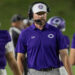 THS-CHS-FB-37 | Press Pass Sports Football coach wearing a purple polo and headset on the sideline during a game at night.