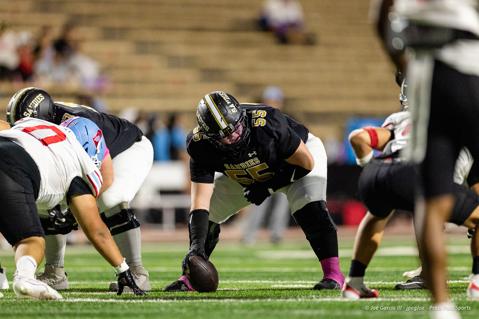 lubbock-monterey-vs-amarillo-high-football-jpegJoe-pps-17 | Press Pass Sports Sandies football center snaps the ball at the line of scrimmage as teammates block nearby.
