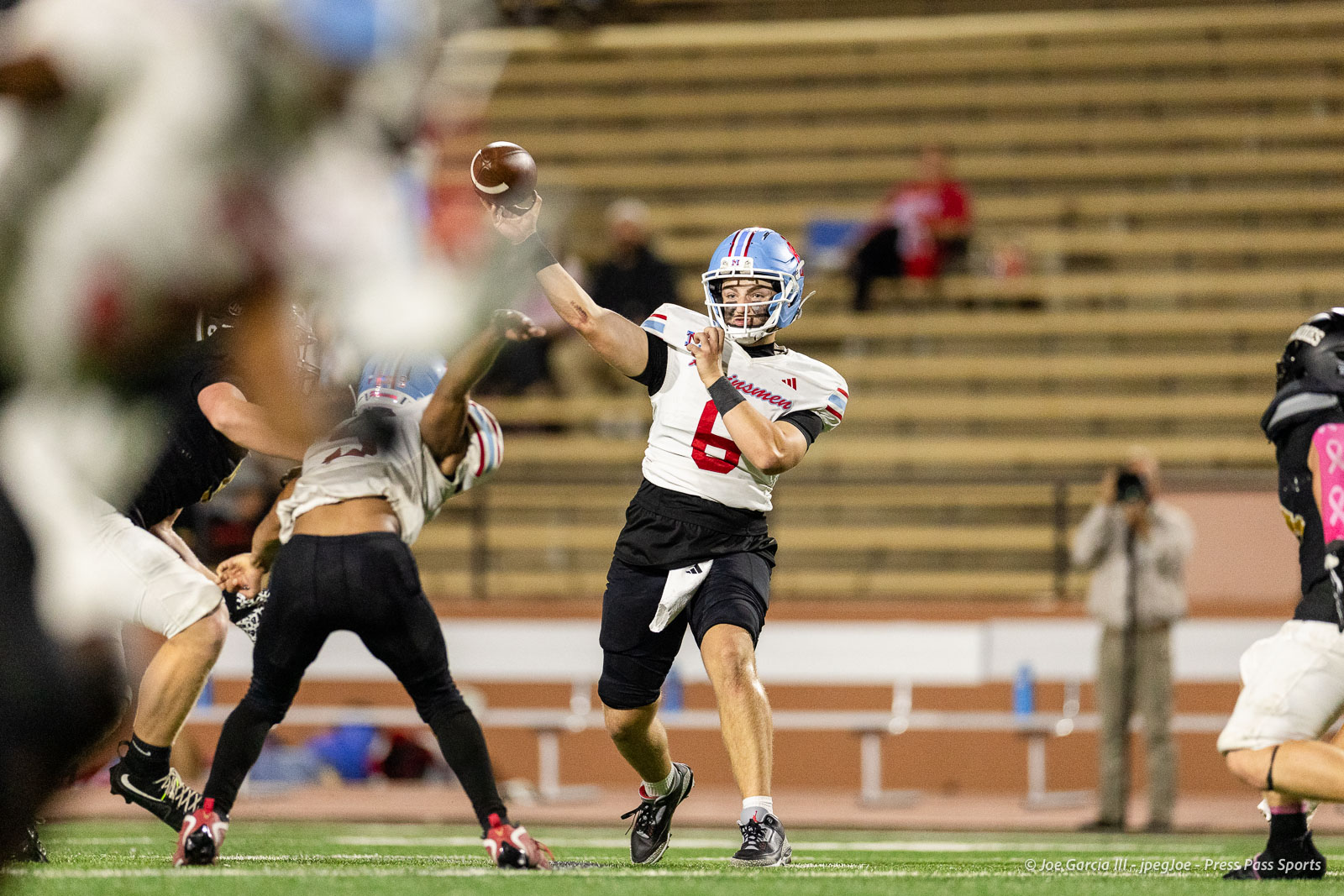 lubbock-monterey-vs-amarillo-high-football-jpegJoe-pps-31 | Press Pass Sports Quarterback in white jersey number 6 and blue helmet throws a pass during a football game.