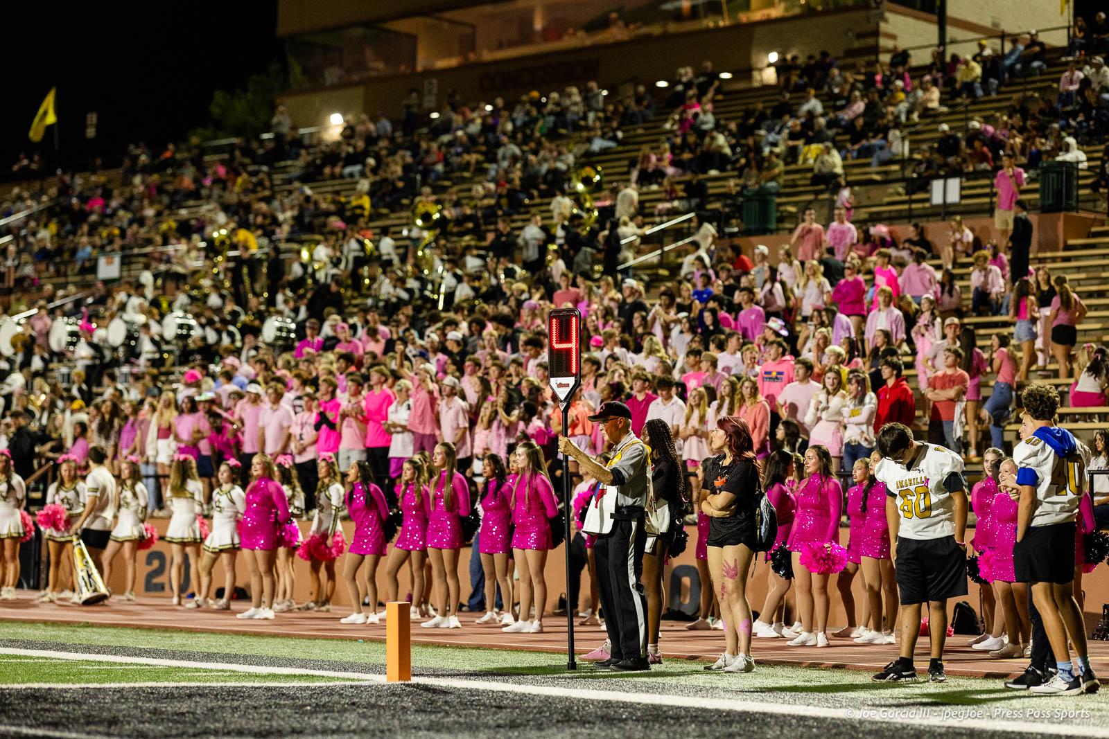 lubbock-monterey-vs-amarillo-high-football-jpegJoe-pps-35 | Press Pass Sports A stadium sideline full of cheerleaders in pink outfits, band members, and a crowd watching a nighttime football game.