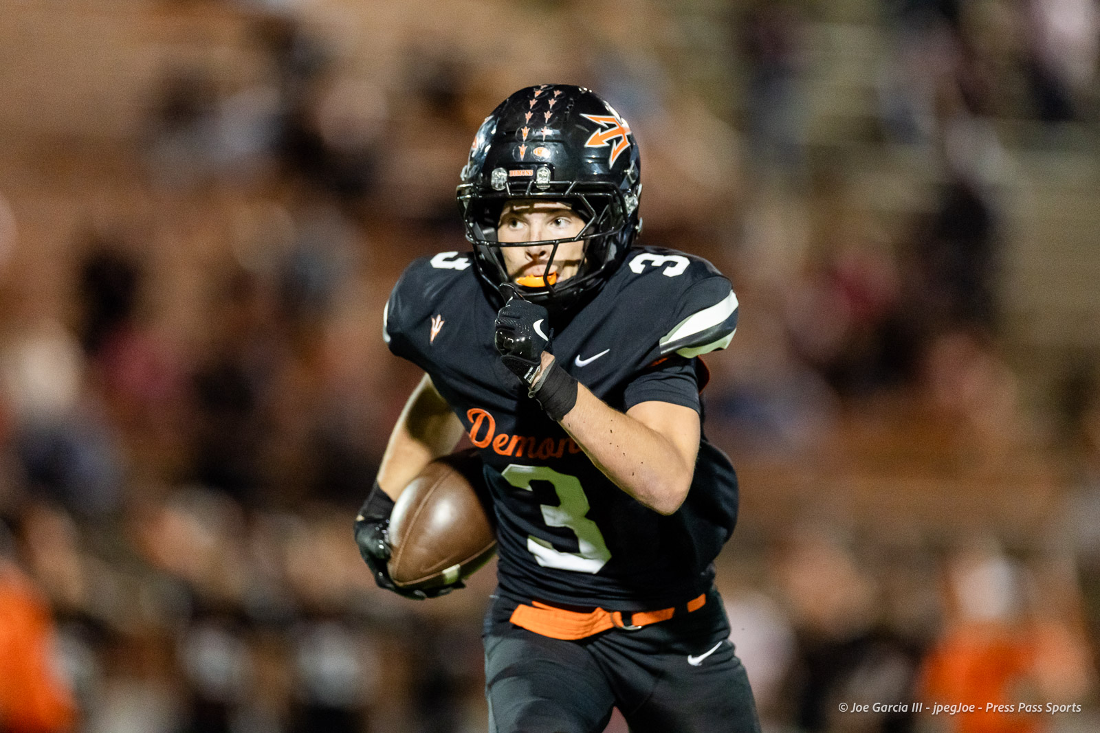 west-plains-vs-dumas-football-jpegJoe-pps-61 | Press Pass Sports Football player in a black uniform number 3 runs with the ball during a game.