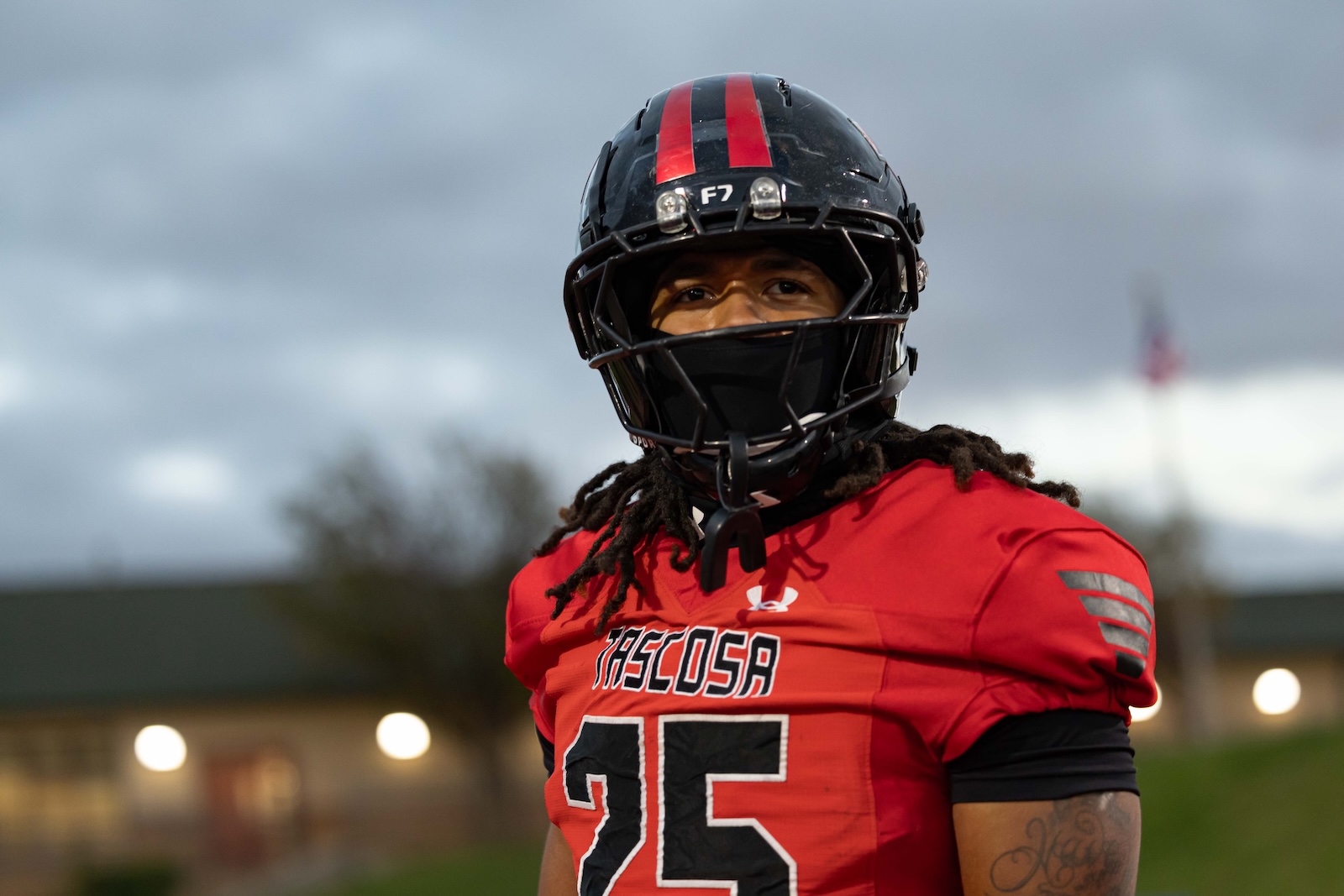 MHS-THS-FB-7 | Press Pass Sports Tascosa football player in a red jersey and black helmet with red stripes, standing outdoors and looking ahead.
