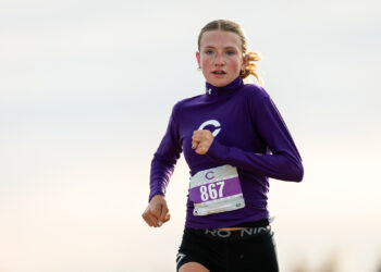 district-4a-canyon-xc-jpegJoe-pps-6 | Press Pass Sports Female runner in a purple long-sleeve top with bib 867, mid-race outdoors.