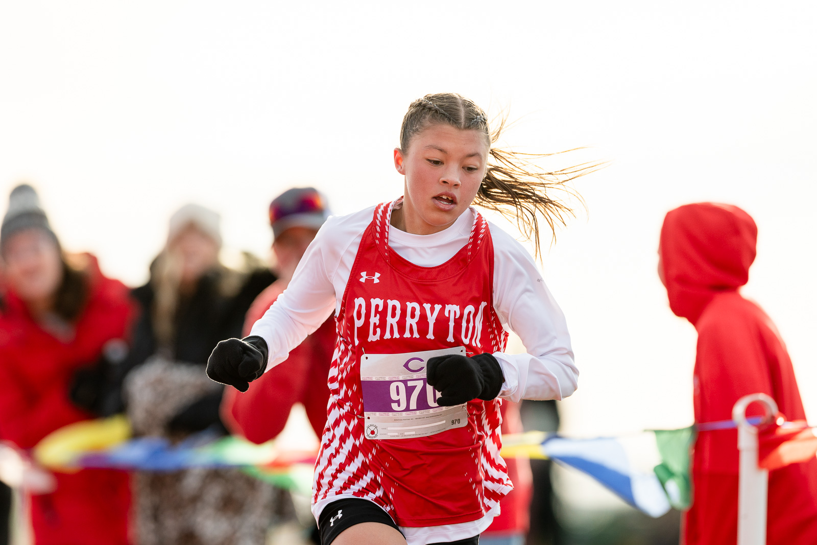 3A-4A-district-xc-jpegJoe-pps-26 | Press Pass Sports Female runner in a red and white racing uniform sprinting, bib number 970, with a crowd blurred in the background.