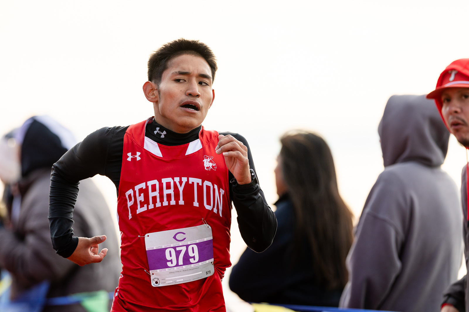 3A-4A-district-xc-jpegJoe-pps-49 | Press Pass Sports Male runner in a red Perryton singlet with bib 979, mid-stride in a race outdoors.