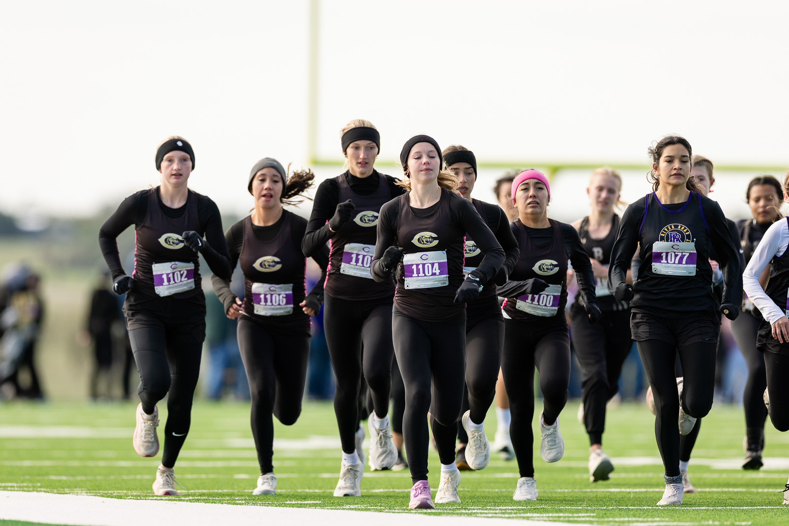 3A-4A-district-xc-jpegJoe-pps-57 | Press Pass Sports Group of female runners in black outfits sprinting on a track at the start of a race, bib numbers visible