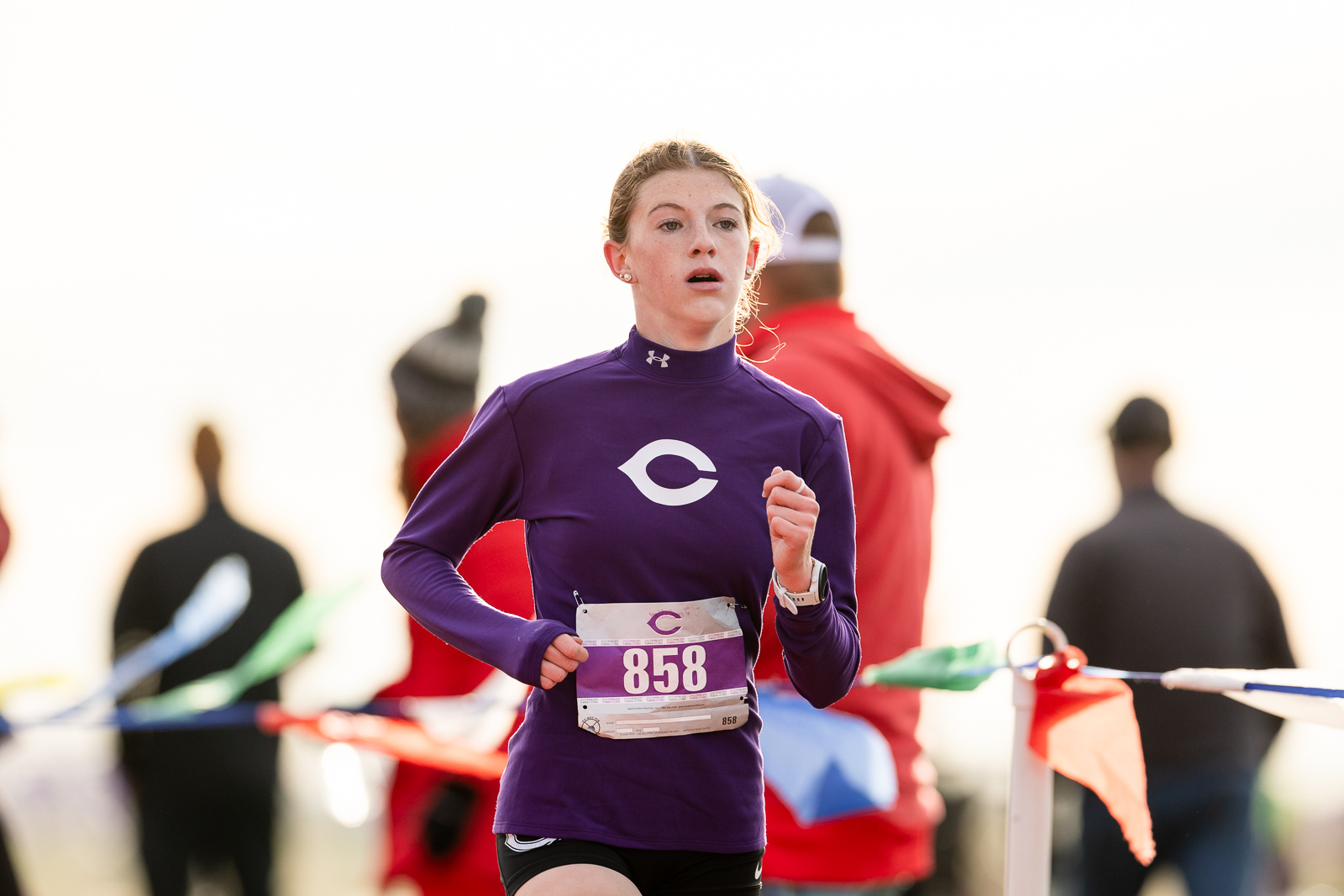 canyon-eagles-district-xc-jpegJoe-pps-11 | Press Pass Sports Female runner in a purple long-sleeve top with bib 858, mid-race and focused on the course.