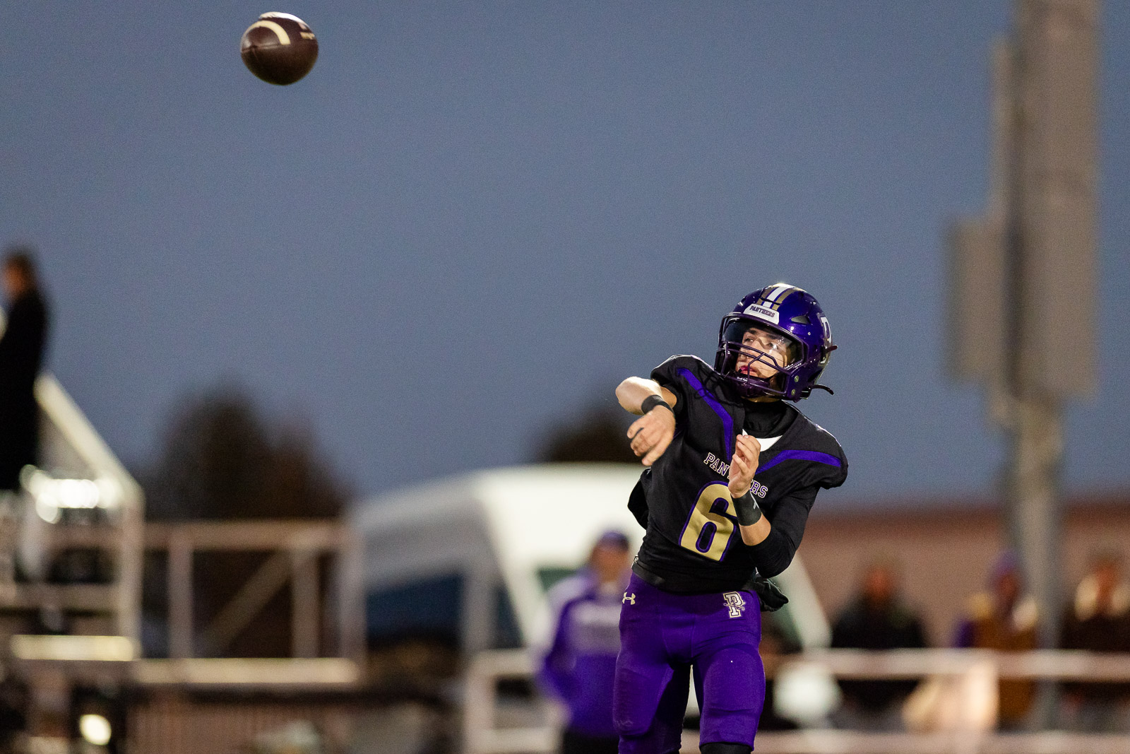 spearman-vs-panhandle-football-jpegJoe-pps-14 | Press Pass Sports Quarterback in a purple uniform throws a pass during a dusk football game.