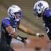 20261016-AWylie-PD-FB-022 | Press Pass Sports Two football players in blue and black uniforms collide mid‑play on the field.