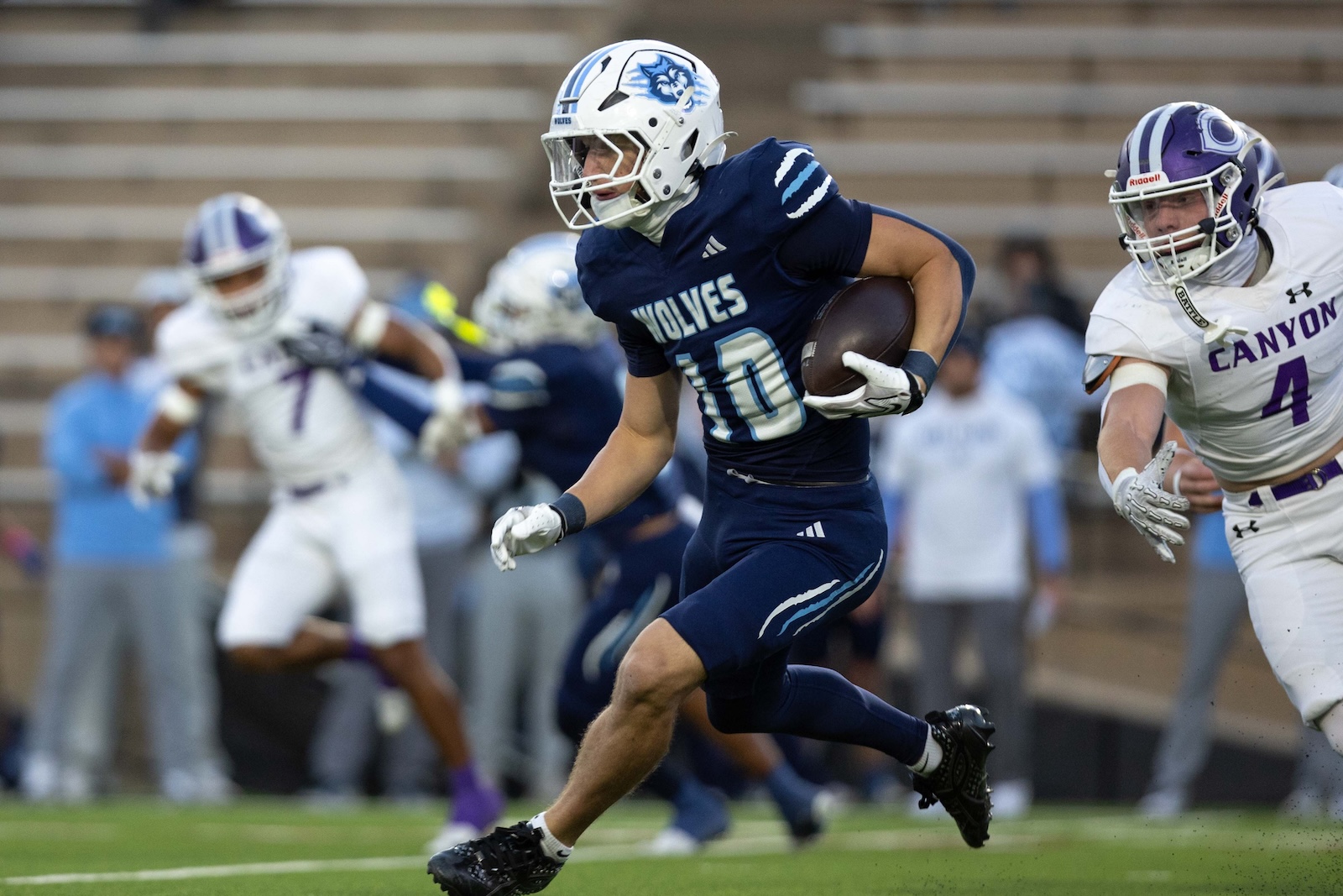 CHS-WPHS-FB-11 | Press Pass Sports Wolves running back with the ball, number 10, sprinting downfield as Canyon defenders close in.