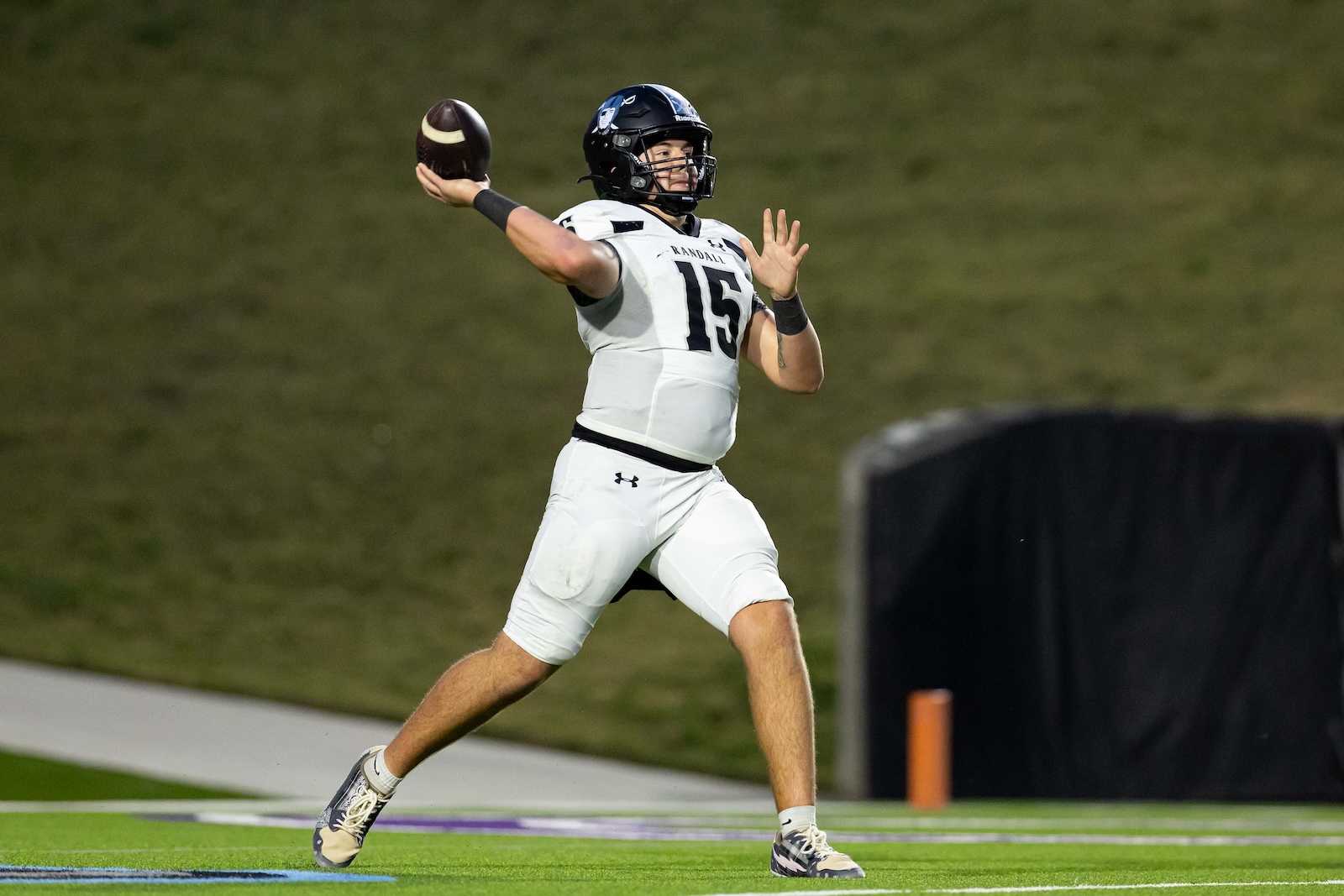 RHS-CHS-FB-7 | Press Pass Sports Quarterback in a white No. 15 uniform throwing a football on a green turf field.