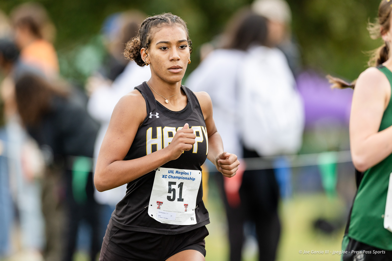 regional-xc-lubbock-2026-jpegJoe-pps-8 | Press Pass Sports Female cross-country runner in a black sleeveless top with bib 51, competing in a UIL Region I XC Championship race.